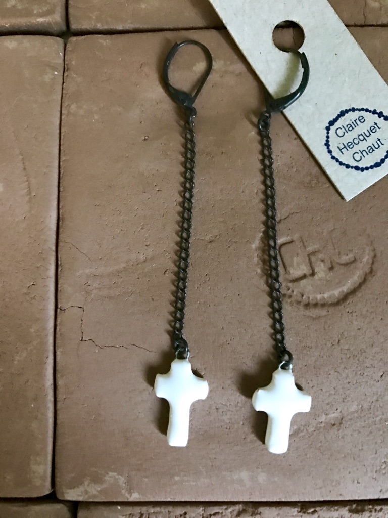 Earrings made of thin ceramic representing a mini cross