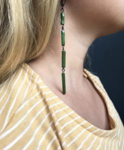 Graphic earrings as a set of thin emerald green rectangular ceramic elements