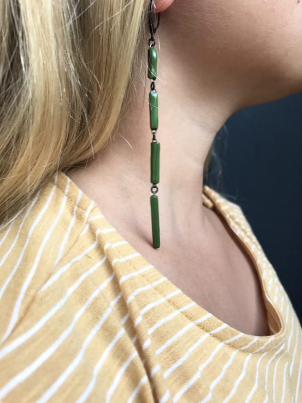 Graphic earrings as a set of thin emerald green rectangular ceramic elements