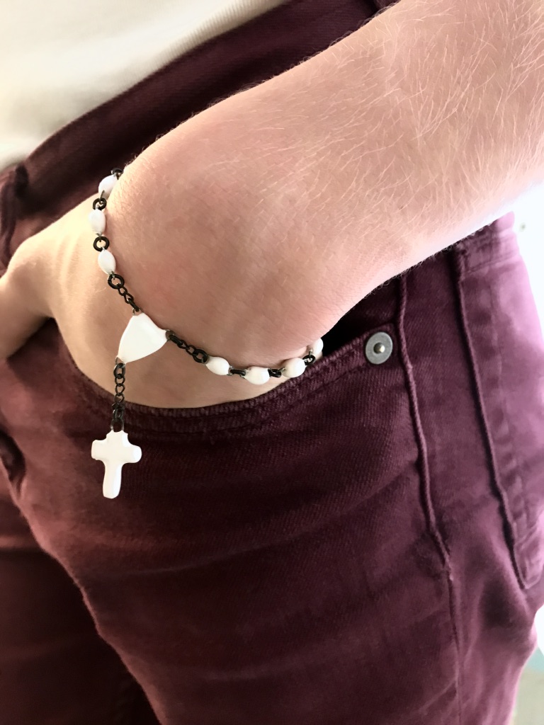 Cross ceramic bracelet consist of small hand made beads, a sacred hart shaped bead and a very tiny ceramic cross