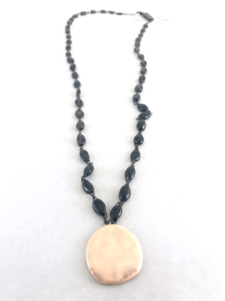 Mid length ceramic navy necklace made of cowrie shaped beads. Made in France